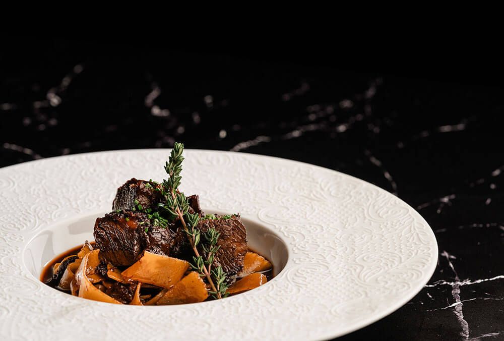 Seafood stew with clams, mussels, and fresh catch in a saffron–tomato broth.